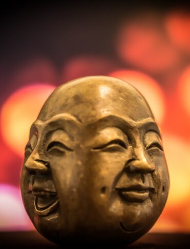 selective focus photography of buddha bust decor